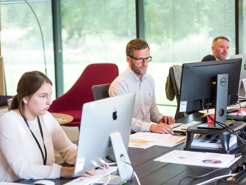 hireEZ colleagues collaborating around a table